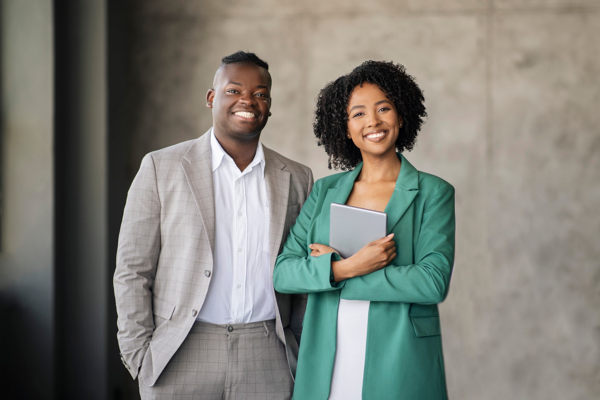 Cheerful African American Coworkers Pair Posing With Tablet In Office